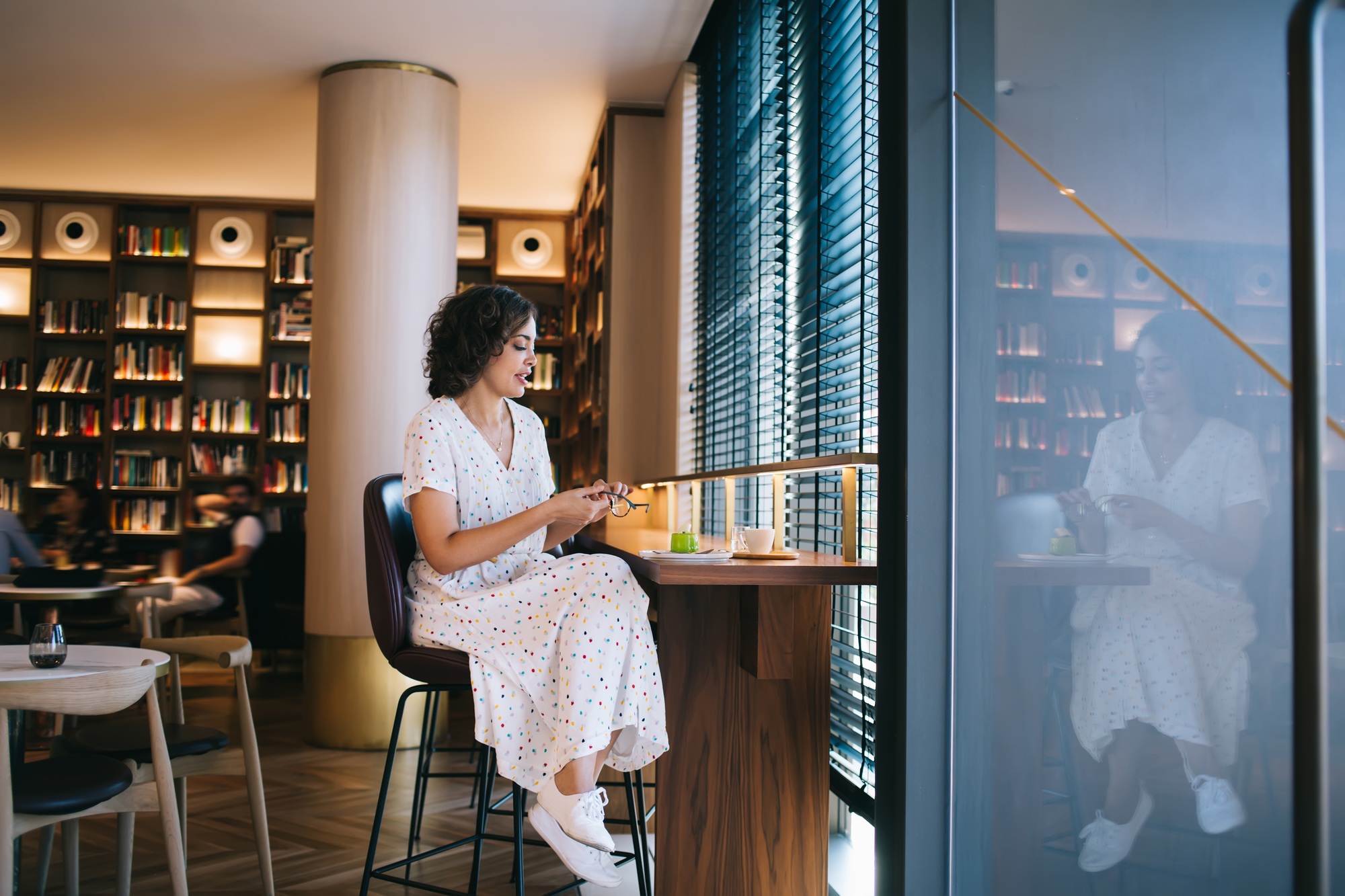 Woman at table with dessert and beverage in book store